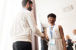 Man and woman shaking hands at conference